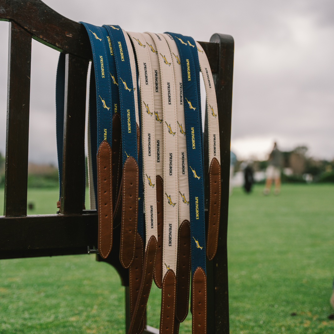Springbok webbing belts hanging on a bench beside the course