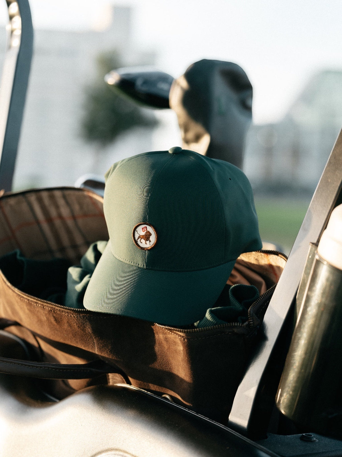 Golfer in a green lion-patch cap with Lion's Head behind