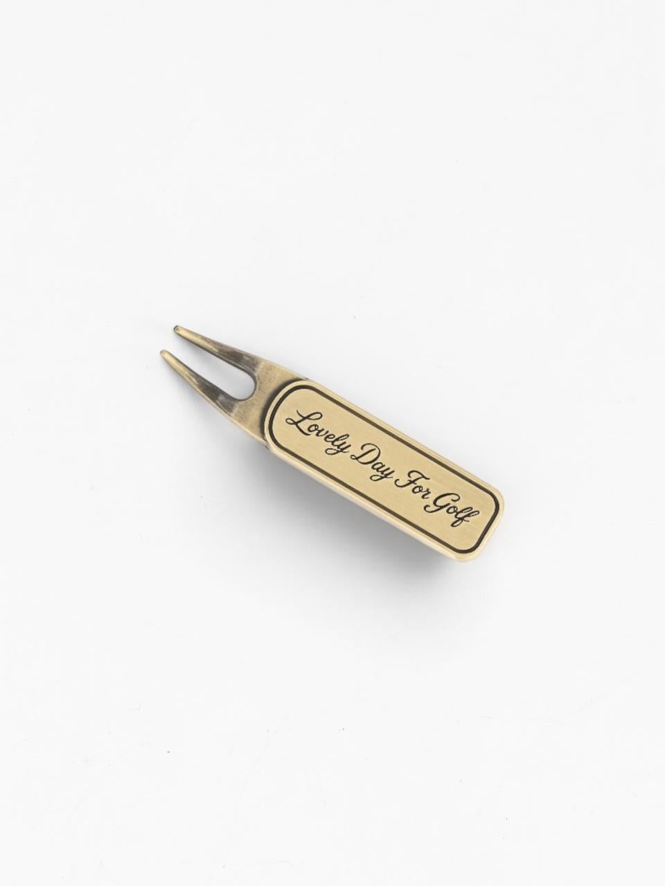 Brass divot tool, angled view of the two prongs