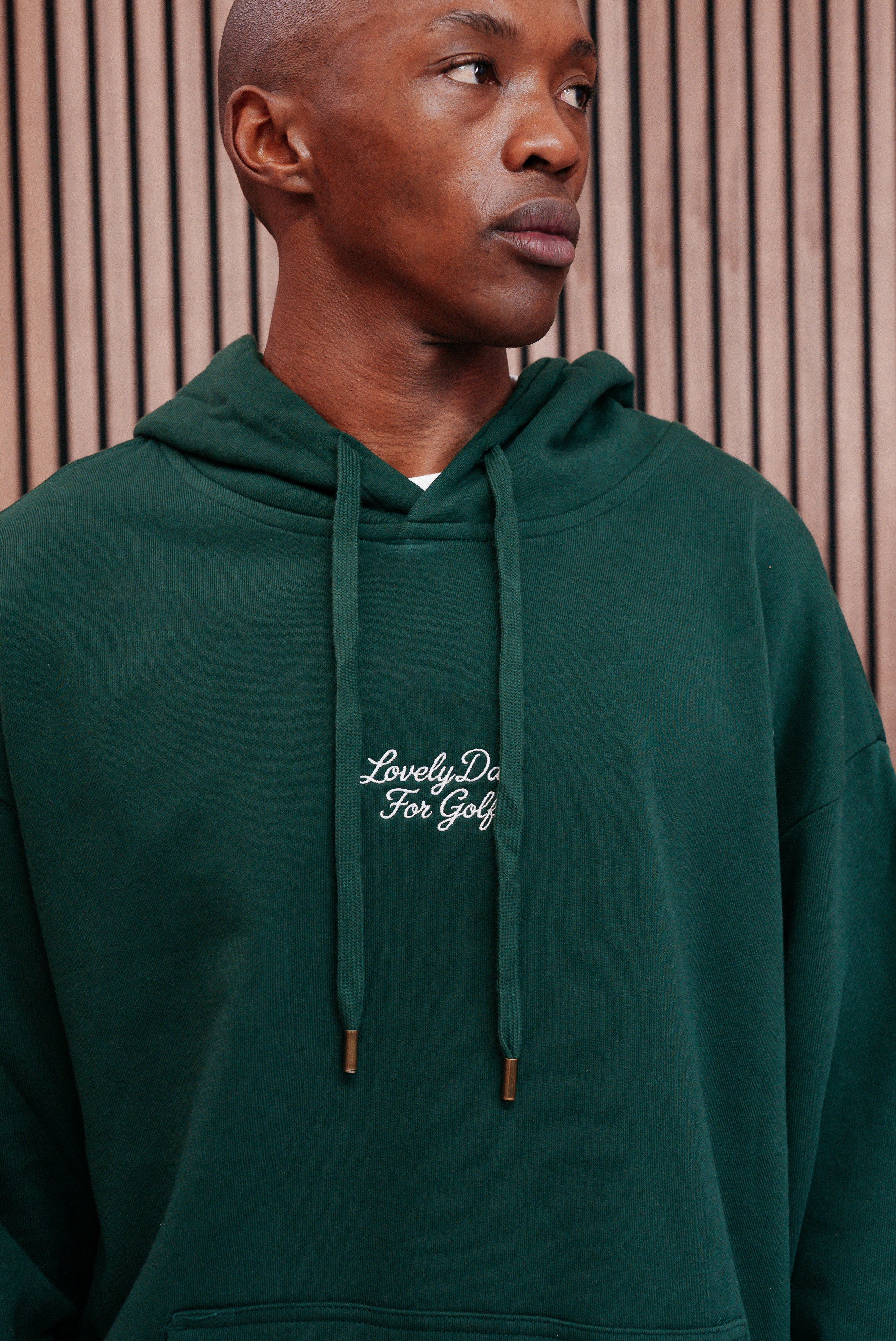 Hood and drawstring detail on the forest green hoodie