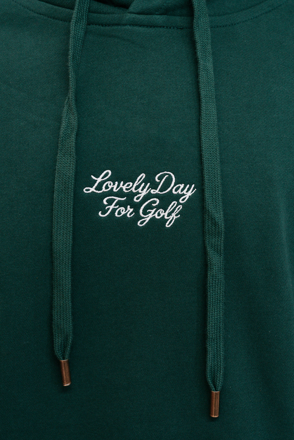 Cream script Lovely Day For Golf chest embroidery on the forest green hoodie