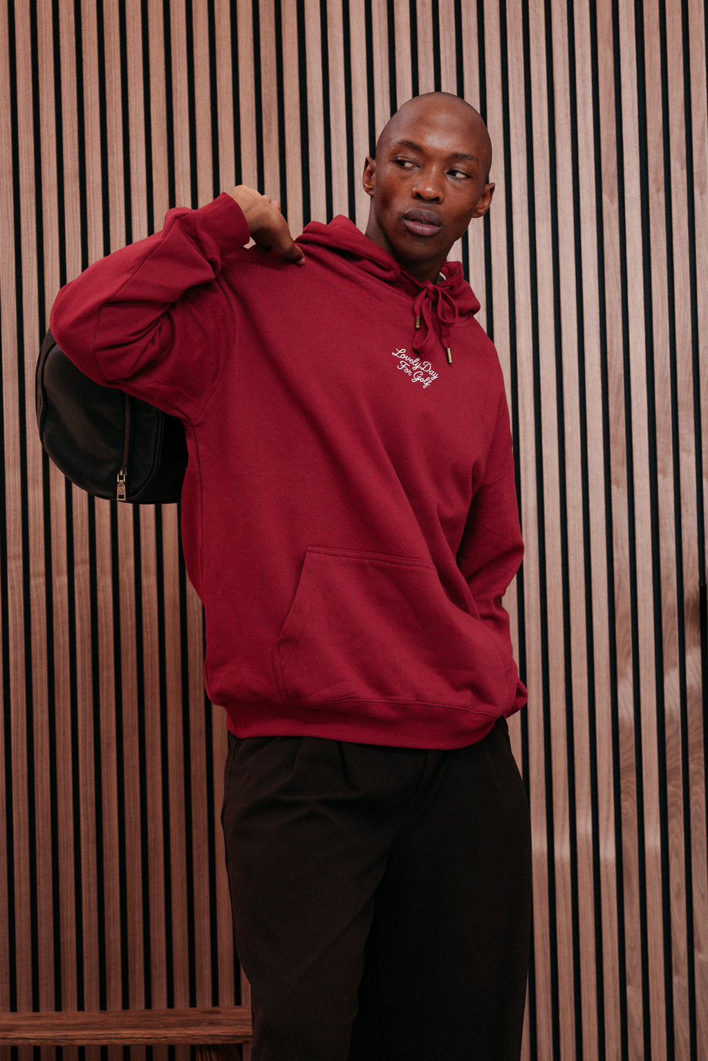 Burgundy hoodie with the hood pulled up