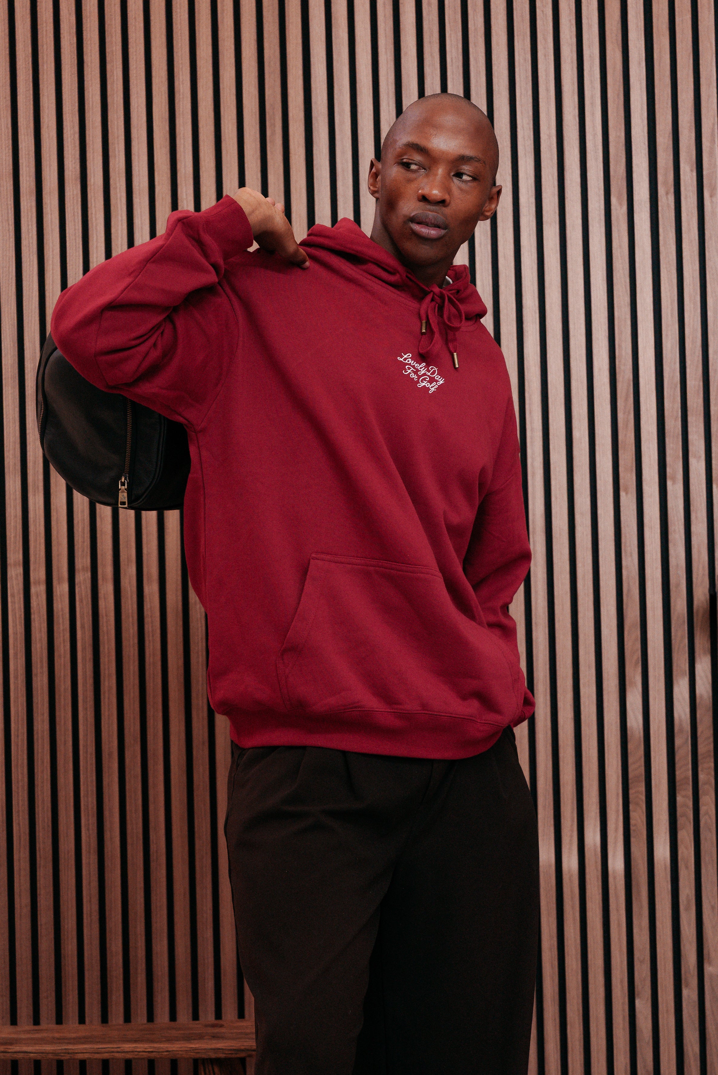 Burgundy hoodie with the hood pulled up