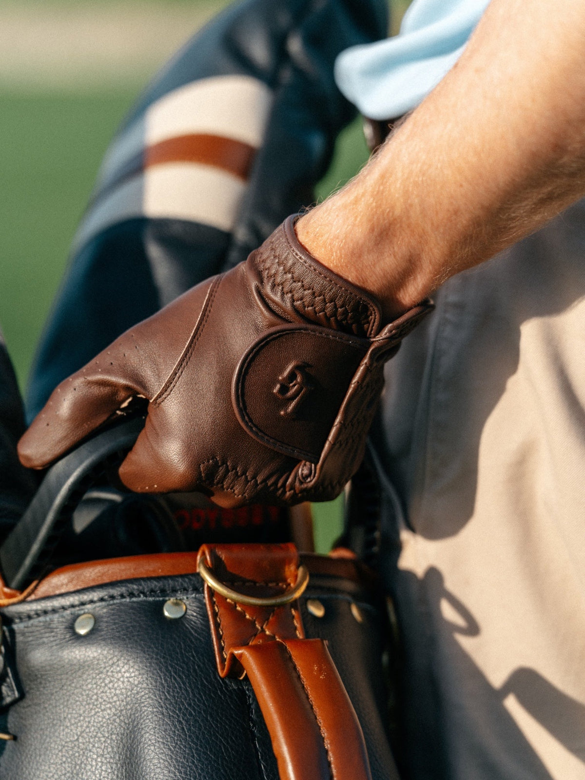 Lovely Day For Golf chocolate brown leather golf glove resting on a golf bag